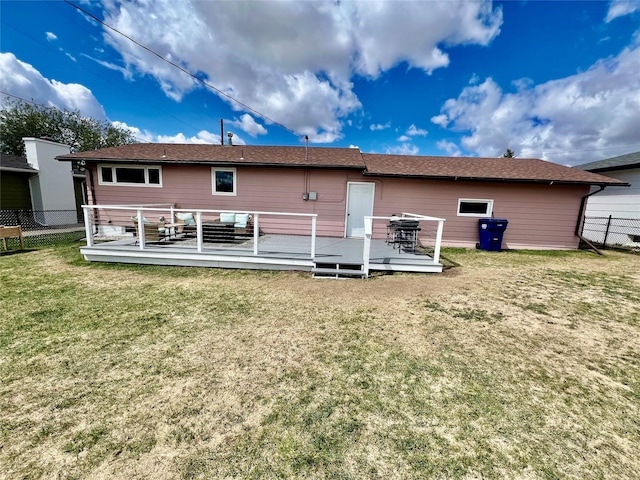 back of house with a lawn, fence, and a wooden deck