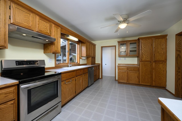 kitchen featuring a sink, appliances with stainless steel finishes, under cabinet range hood, and brown cabinets