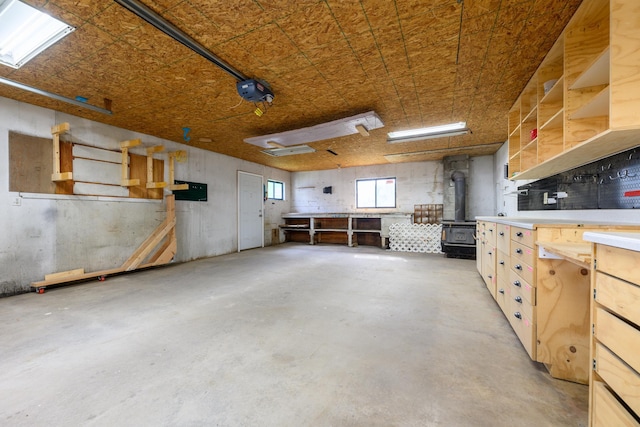 garage featuring a workshop area and a wood stove