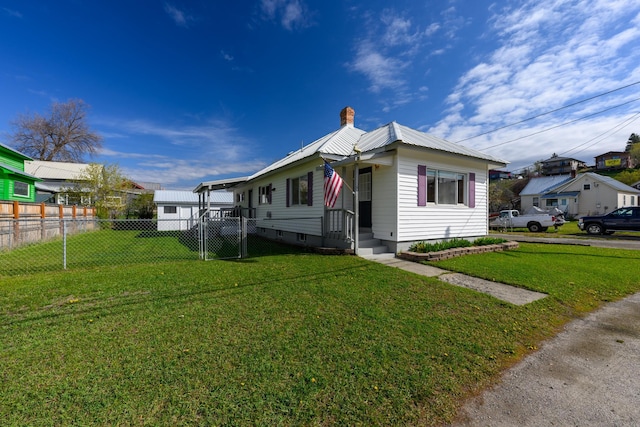 bungalow-style home with fence, a front lawn, a gate, a chimney, and metal roof