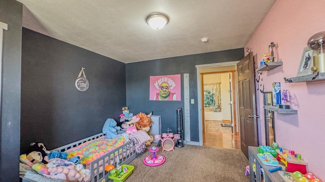 bedroom featuring carpet flooring and a textured ceiling