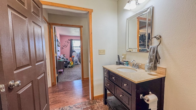 bathroom with wood finished floors and vanity
