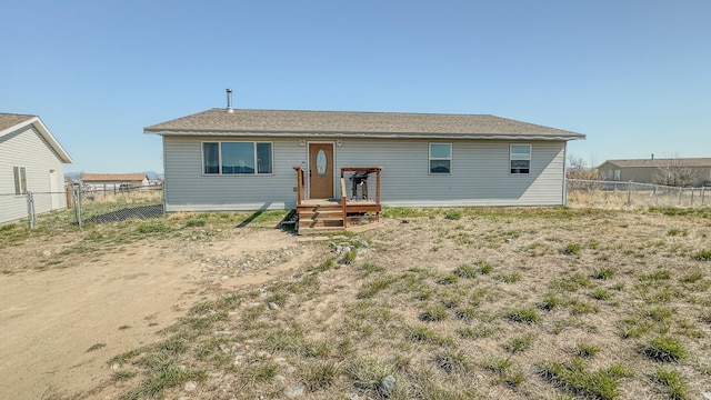 rear view of house featuring fence