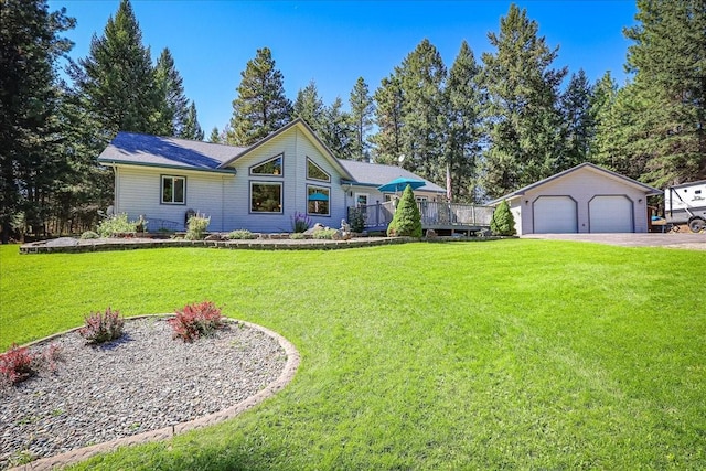 261 Green Briar Trl, Eureka, MT 59917 - view of front of property featuring a deck, an outbuilding, a front yard, and a detached garage