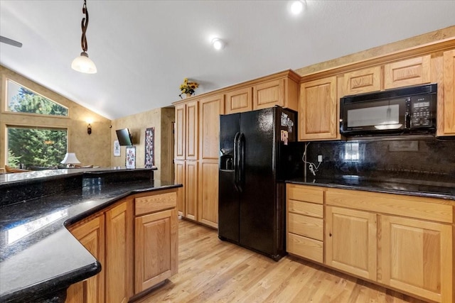 261 Green Briar Trl, Eureka, MT 59917 - kitchen featuring decorative light fixtures, tasteful backsplash, vaulted ceiling, black appliances, and light wood-style flooring