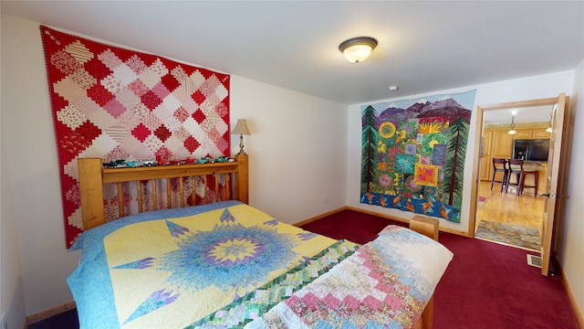 261 Green Briar Trl, Eureka, MT 59917 - bedroom with baseboards, carpet flooring, black fridge, and visible vents