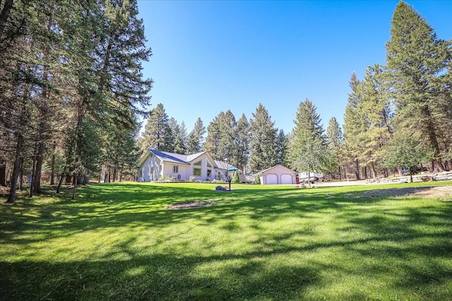 261 Green Briar Trl, Eureka, MT 59917 - view of property's community with a detached garage and a lawn