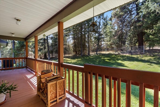 261 Green Briar Trl, Eureka, MT 59917 - deck featuring a lawn, fence, and covered porch