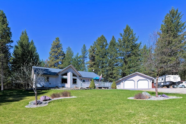 261 Green Briar Trl, Eureka, MT 59917 - view of front of house with a detached garage, an outdoor structure, aphalt driveway, and a front yard