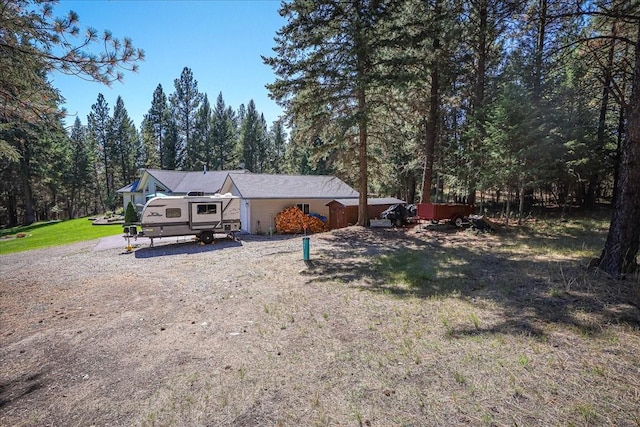 261 Green Briar Trl, Eureka, MT 59917 - view of front facade featuring a wooded view and a front lawn