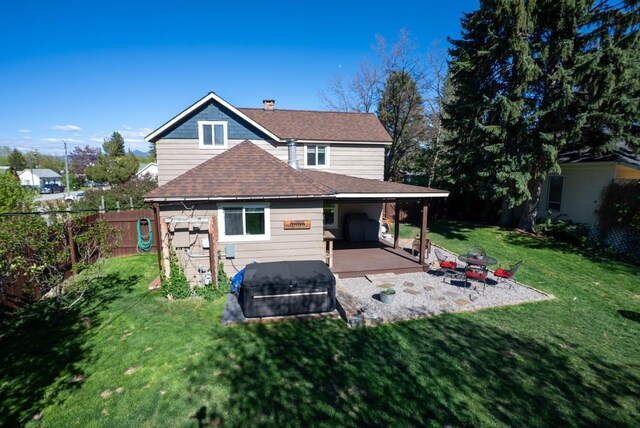 617 N 5th St, Hamilton, MT 59840 - rear view of property featuring a hot tub, a shingled roof, a deck, and a chimney