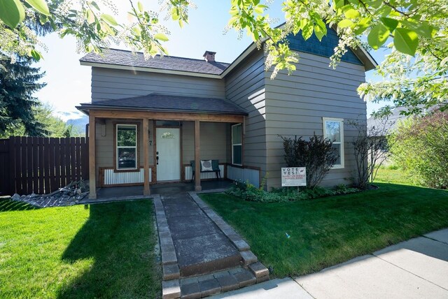 617 N 5th St, Hamilton, MT 59840 - view of front of house featuring covered porch, a chimney, and a shingled roof