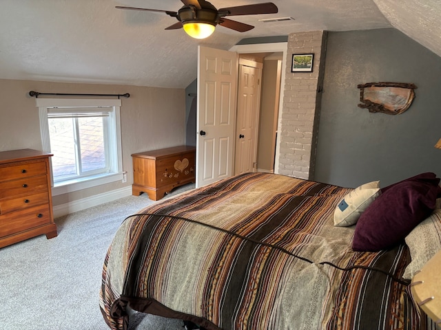 carpeted bedroom featuring ceiling fan, a textured ceiling, visible vents, vaulted ceiling, and baseboards