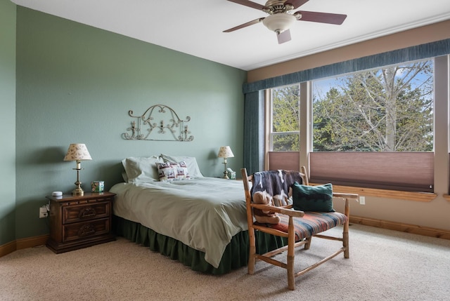 bedroom featuring carpet floors, baseboards, and ceiling fan