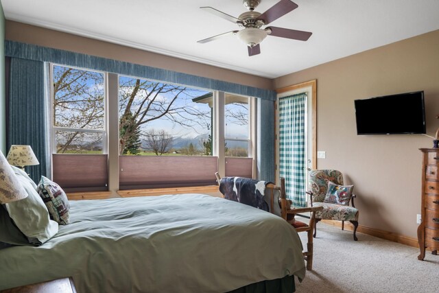 bedroom with baseboards, ceiling fan, and light colored carpet