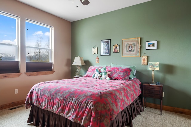 carpeted bedroom with baseboards, ceiling fan, and visible vents