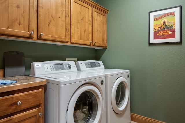 laundry room with separate washer and dryer and cabinet space