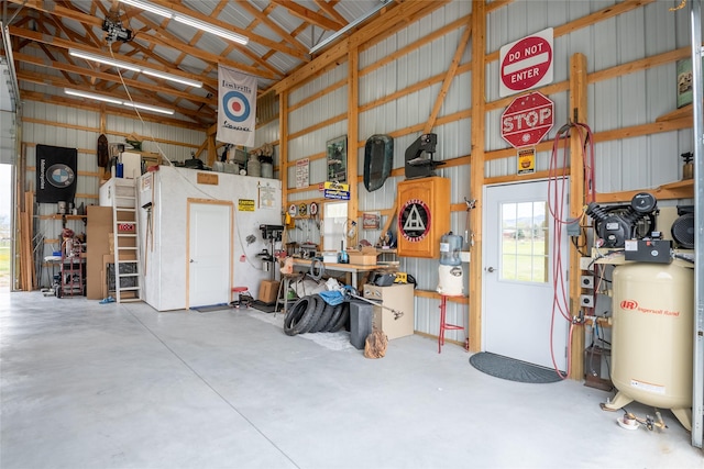 garage featuring metal wall and a workshop area