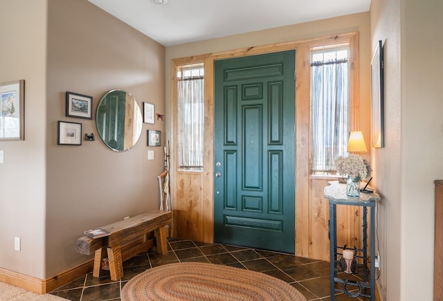entryway featuring dark tile patterned floors