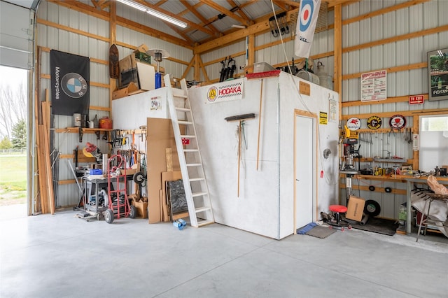 garage with a workshop area and metal wall