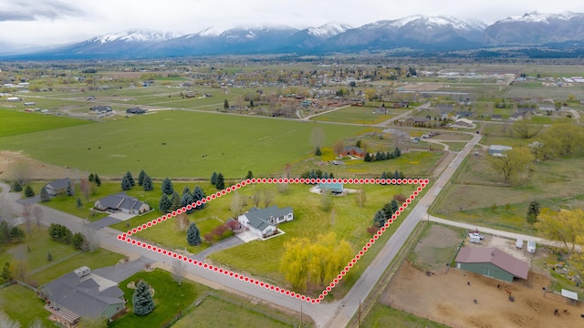 drone / aerial view featuring a mountain view and a rural view