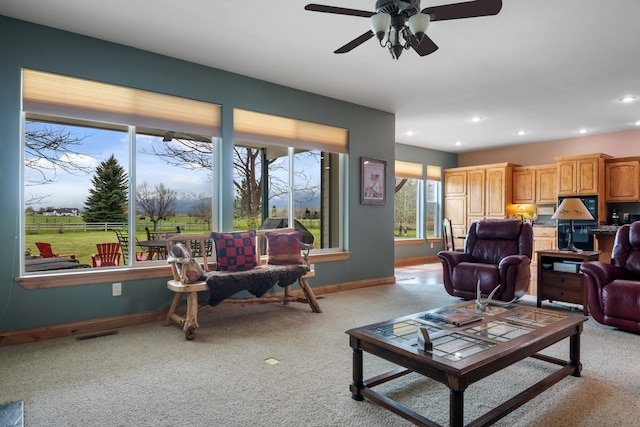 living area with recessed lighting, baseboards, light carpet, and ceiling fan