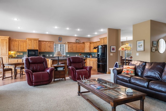 living room with light carpet and recessed lighting