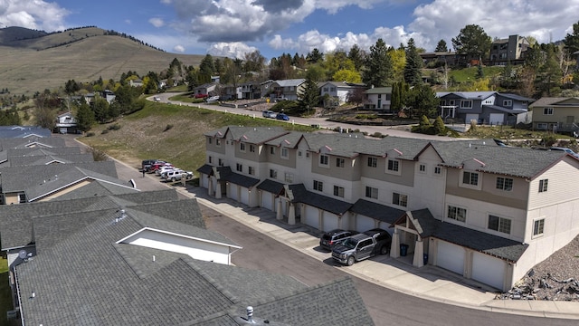 drone / aerial view featuring a residential view and a mountain view
