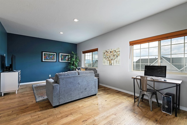 living room featuring recessed lighting, baseboards, and wood finished floors