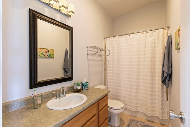 bathroom featuring vanity, tile patterned flooring, and toilet