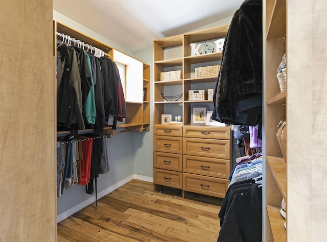 spacious closet featuring light wood-style flooring
