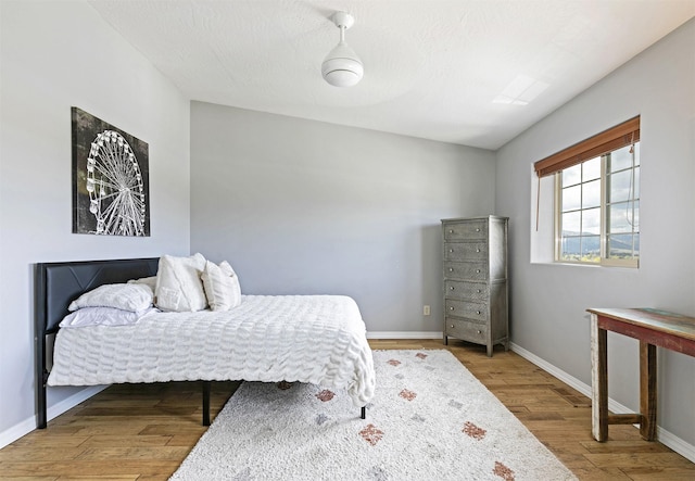 bedroom featuring baseboards and wood finished floors