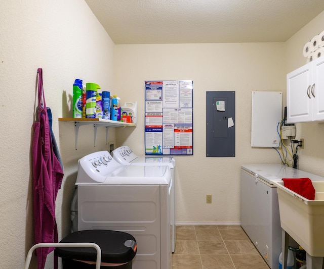 laundry room featuring baseboards, electric panel, washing machine and clothes dryer, a sink, and cabinet space