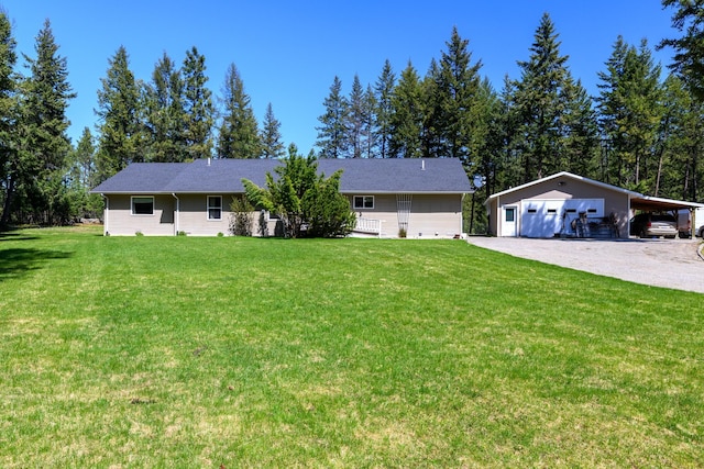 ranch-style house featuring a detached garage, an outdoor structure, and a front yard