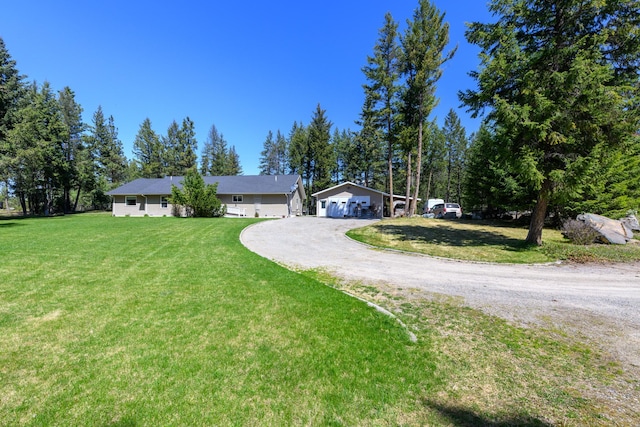 single story home with dirt driveway, a front lawn, and a garage