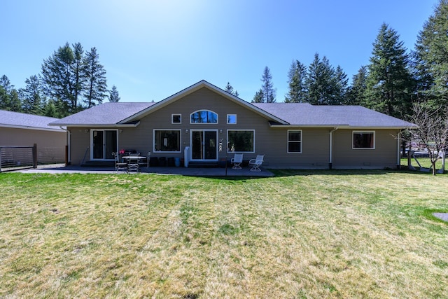 back of property with a patio and a yard
