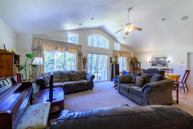 carpeted living area featuring high vaulted ceiling and ceiling fan