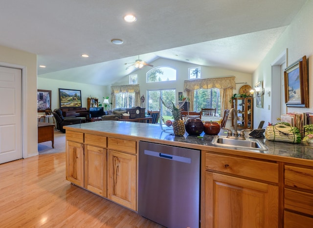 kitchen with stainless steel dishwasher, vaulted ceiling, light wood-type flooring, a sink, and open floor plan