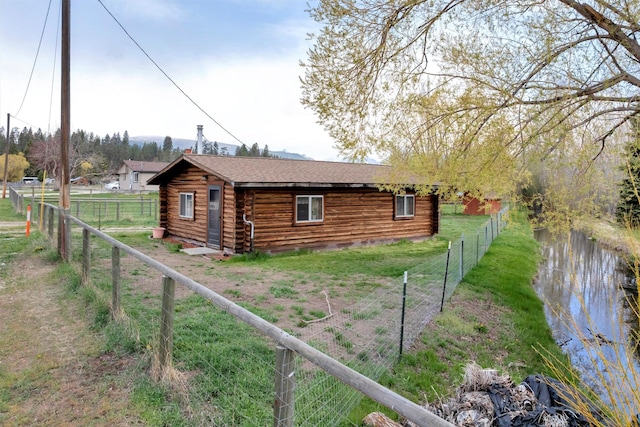 view of property exterior with fence and log siding