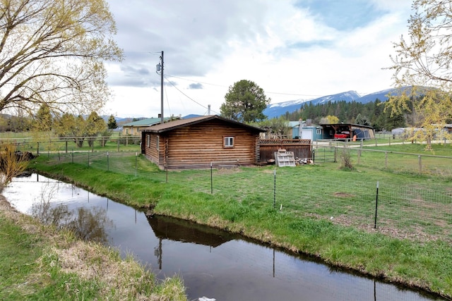 view of yard featuring a mountain view and fence