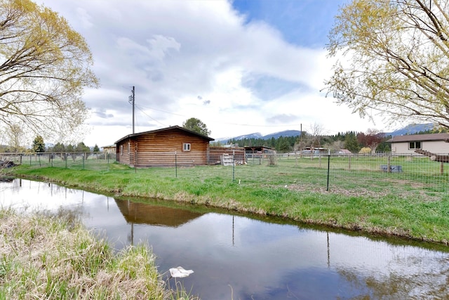 exterior space with a mountain view and fence