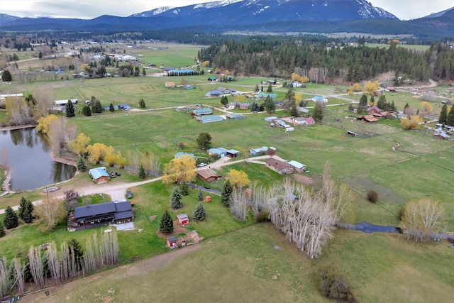 aerial view featuring a rural view and a water and mountain view