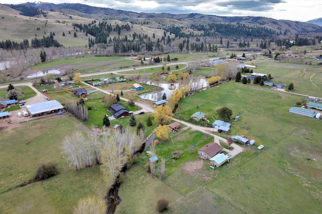 aerial view with a water and mountain view and a rural view