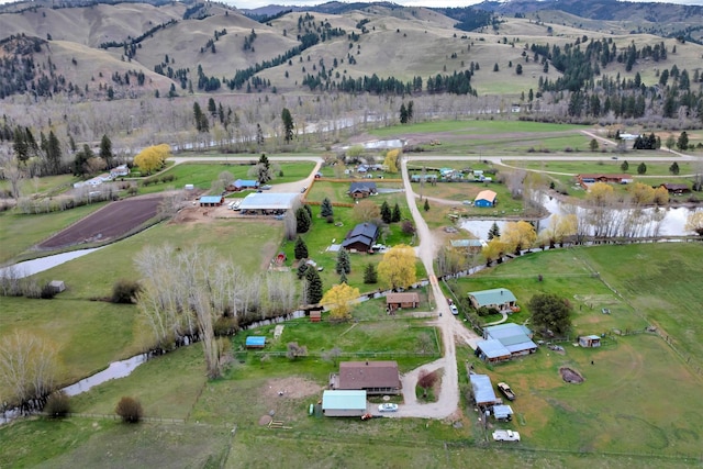 drone / aerial view featuring a rural view and a water and mountain view