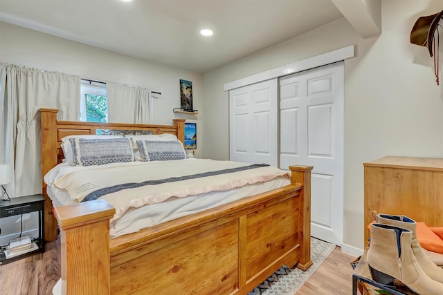 bedroom with recessed lighting, a closet, and light wood-type flooring