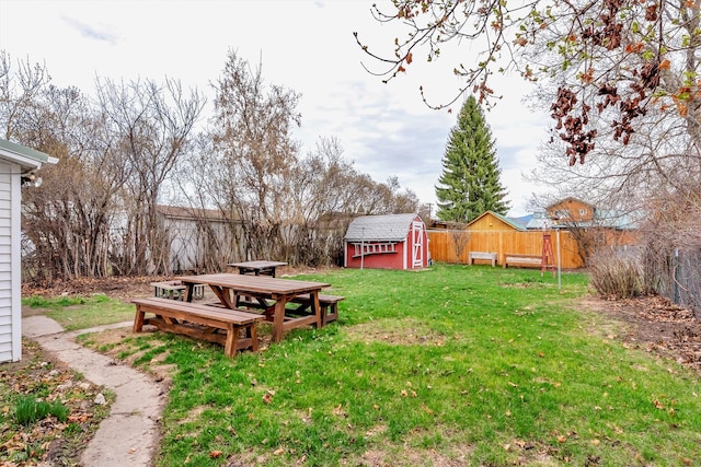 back of property with a yard, a fire pit, and metal roof