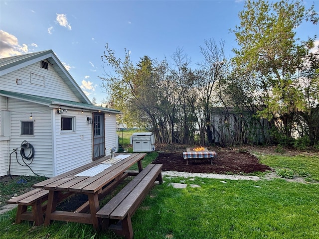 view of yard with fence, an outdoor structure, and a shed