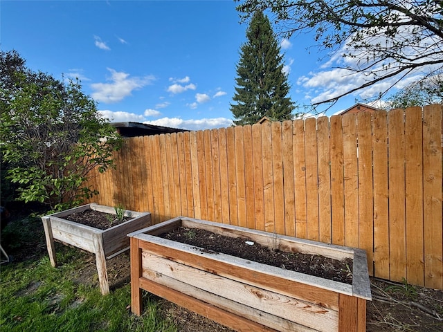 rear view of house with fence, a fire pit, and metal roof