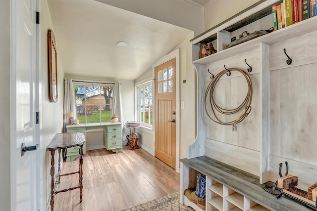 mudroom with baseboards, vaulted ceiling, and light wood-style flooring