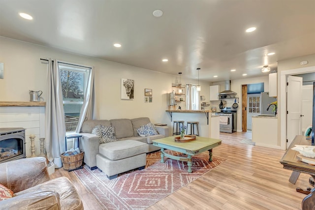 living area with recessed lighting and light wood-style floors